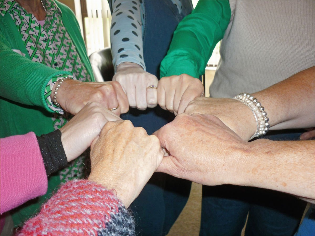 Hands joined in a psychodrama group circle
