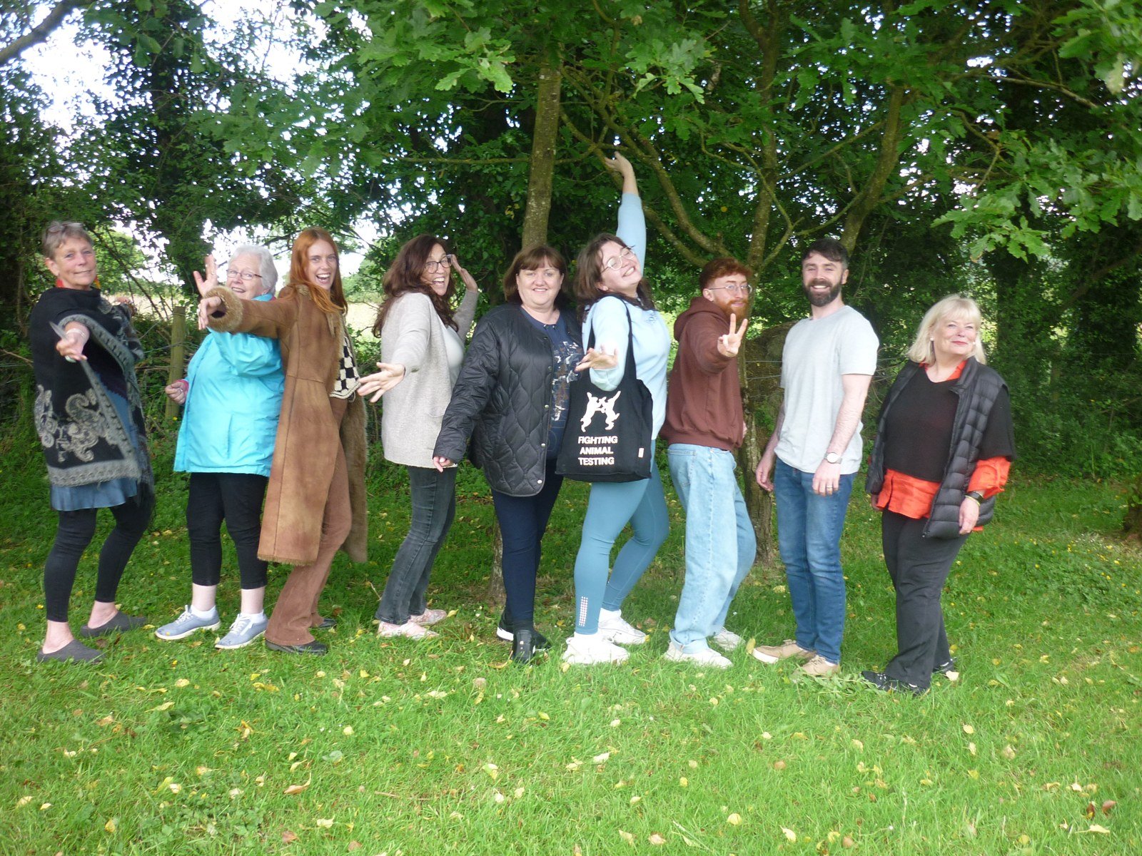 Workshop participants standing together beneath trees